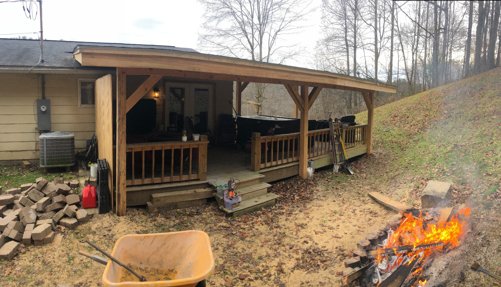 Large covered deck addition with timber posts and hot tub