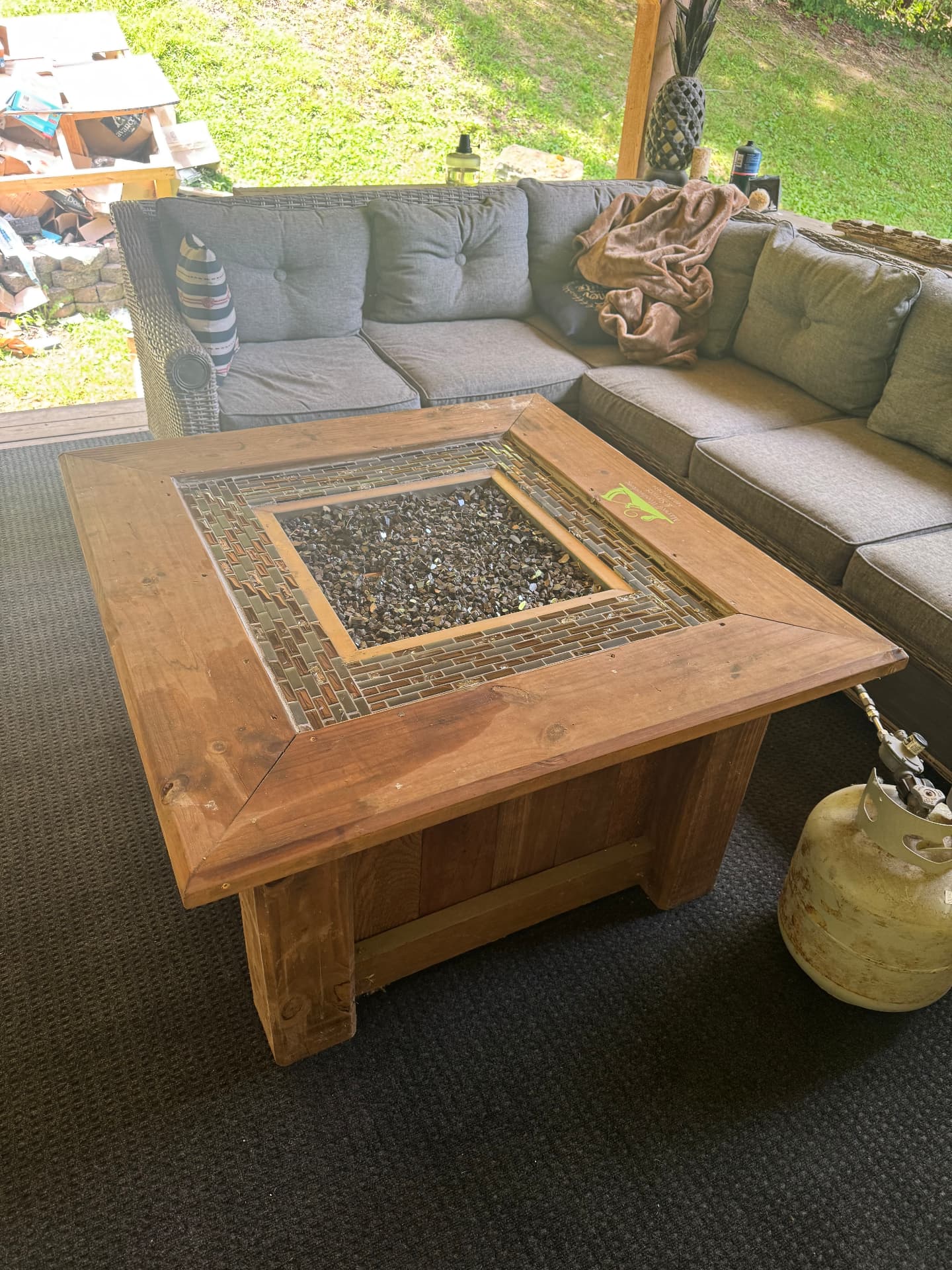 Custom-built wood and tile gas fire table for a covered patio