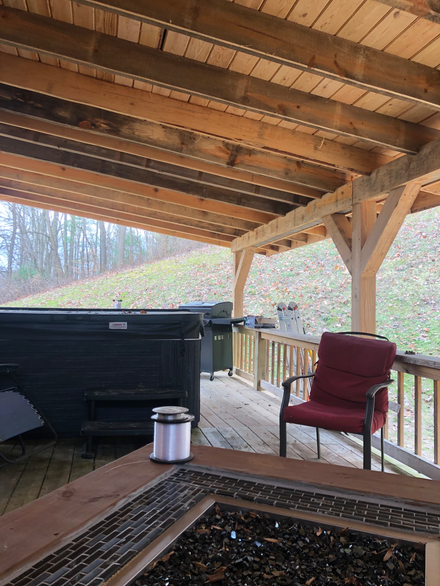 Underside of a covered hot tub deck with exposed rough-sawn rafters