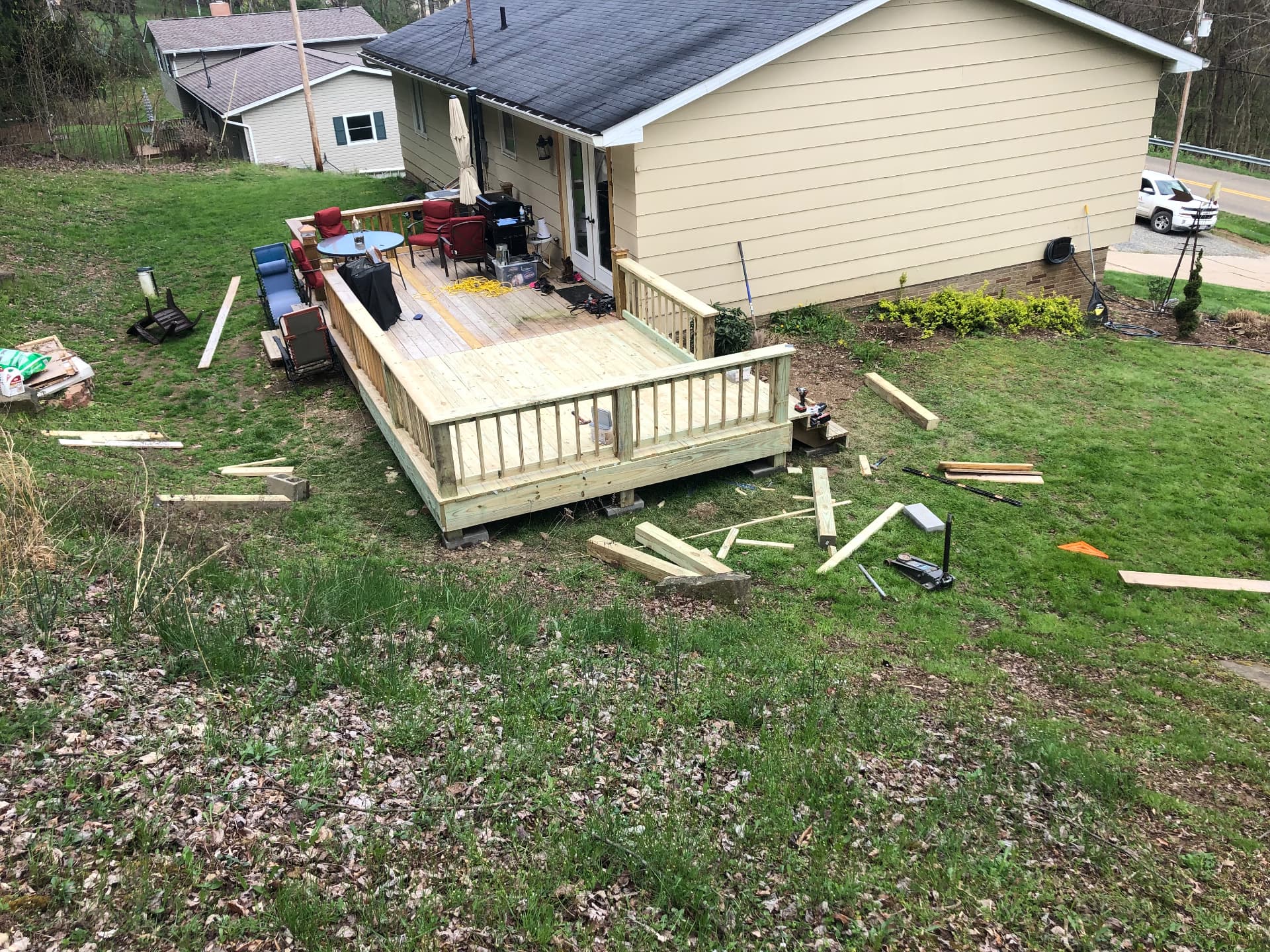Backyard deck expansion with new railing built onto an existing deck