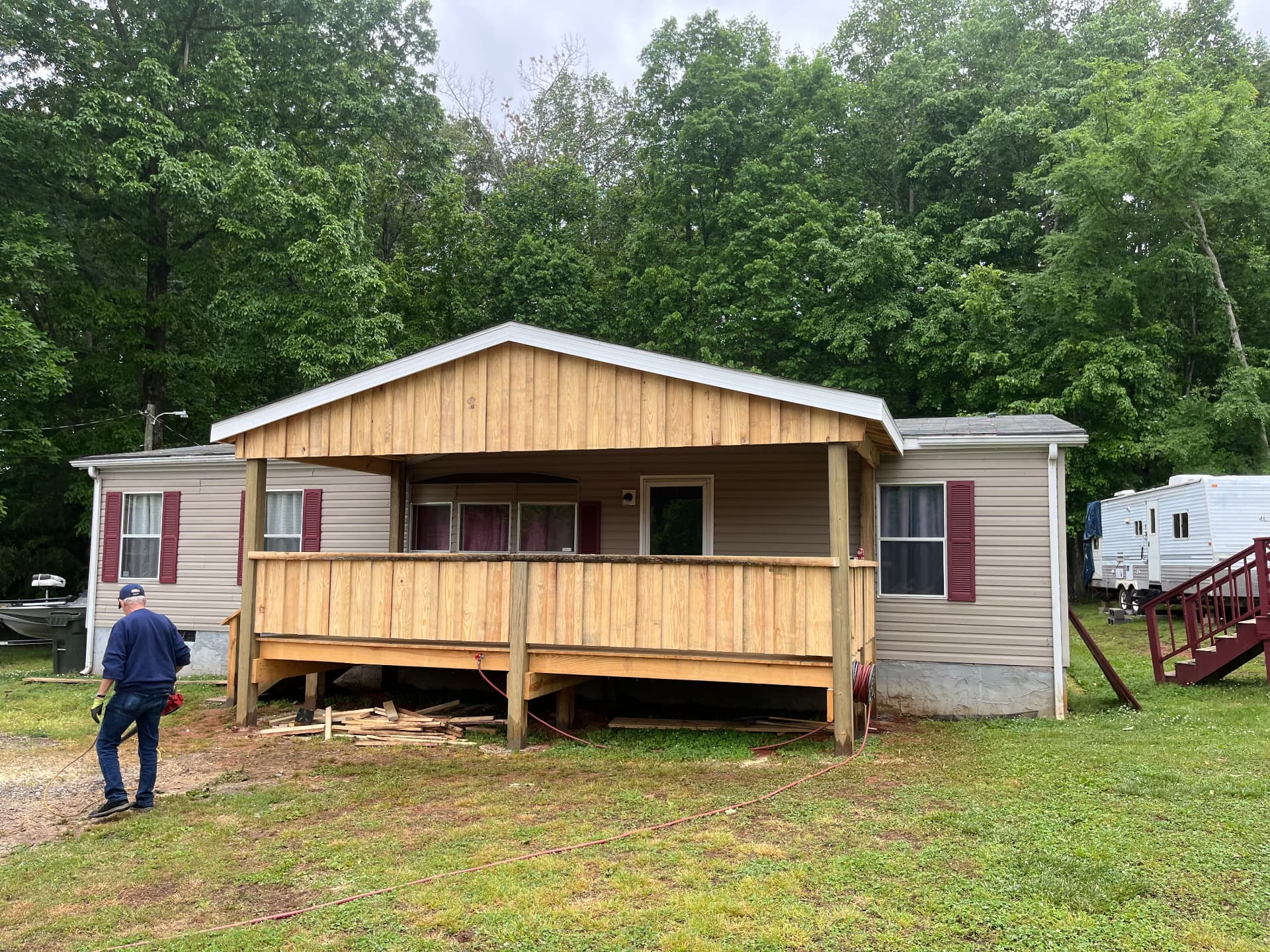 Cedar gable front porch addition with solid wood railing